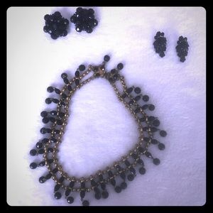 Black choker and black earrings